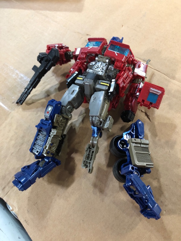 Photo 2 of **LEG BROKEN** QCCX Car Robot Toys, Deformation Robot Toy, Optimus Action Figure, Deformed Car Robot with Weapon for Kids Boys Girls