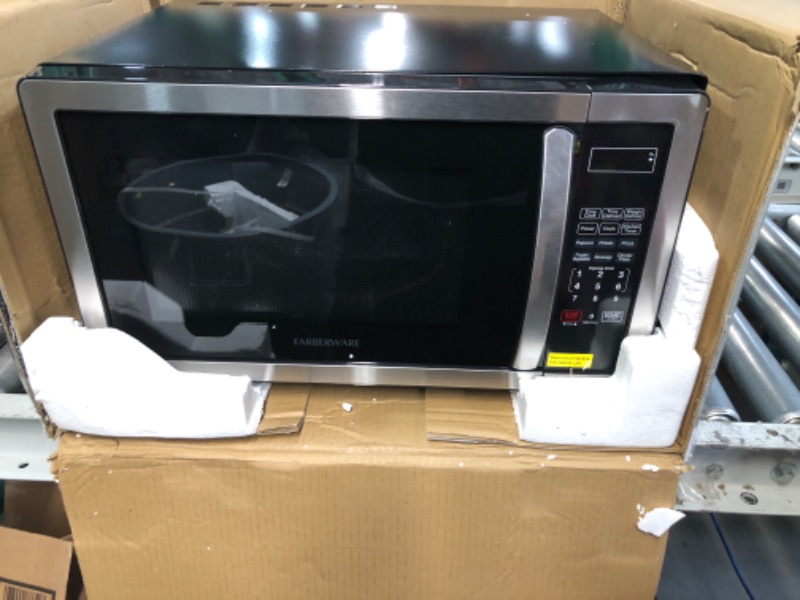 Photo 2 of **DAMAGED**Farberware Countertop Microwave 1.1 Cu. Ft. 1000-Watt Compact Microwave Oven with LED lighting, Child lock, and Easy Clean Interior, Stainless Steel Interior & Exterior