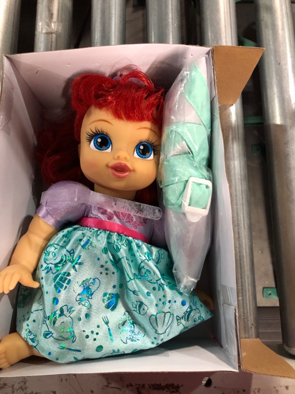 Photo 4 of Disney Princess Ariel Baby Doll Deluxe with Tiara, Carrier, Plush Friend, Pacifier, Bib & Baby Bottle [Amazon Exclusive]