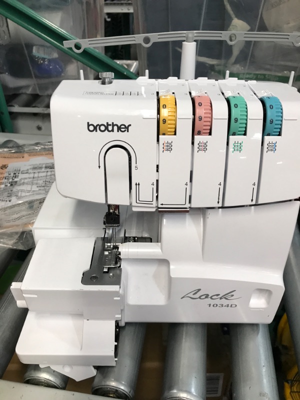 Photo 5 of **USED**Brother Serger, 1034DX, Durable Metal frame Overlock Machine 1,300 Stitches Per Minute, Trim Trap, 3 Accessory Feet and Protective Cover Included