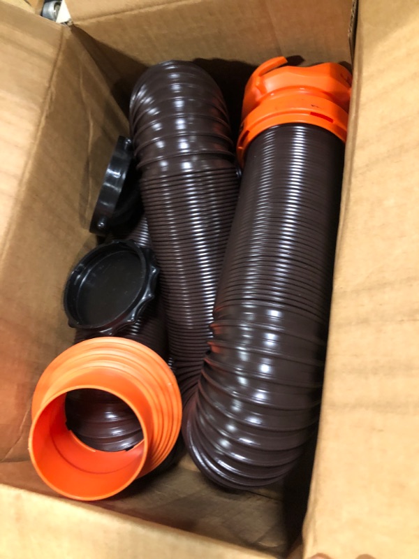 Photo 1 of Camco RhinoFLEX RV Sewer Hose Kit with Swivel Transparent Elbow and 4-in-1 Dump Station Fitting, Brown, 15 Feet (39770) 15ft Sewer Hose Kit Frustration-Free Packaging