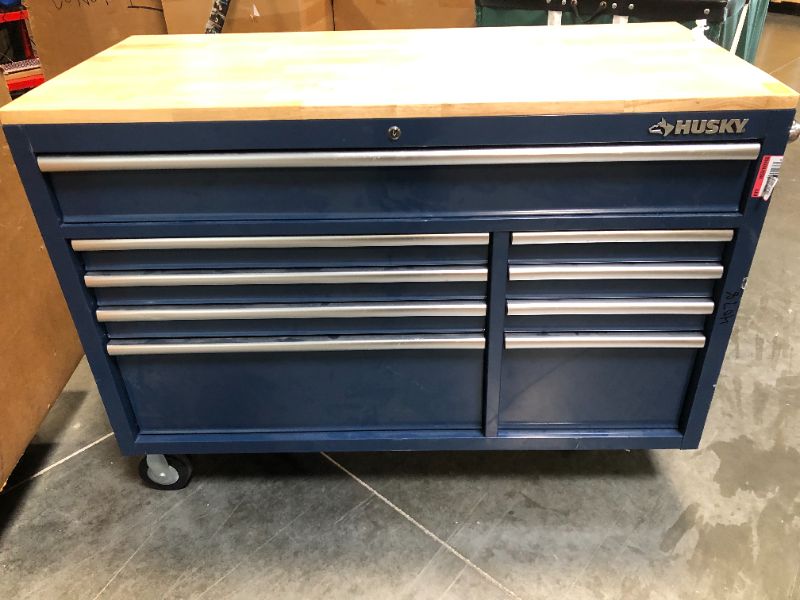 Photo 8 of ***FOR PARTS ONLY***
****************************
Husky 52 in. 18-Drawer Mobile Workbench with Solid Wood Top in Gloss Blue, HOTC7218B31M

***MISSING FRONT WHEELS****

