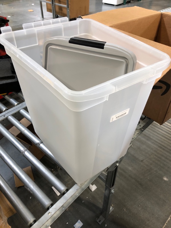 Photo 1 of 65qt clear bin with lid nd wheels