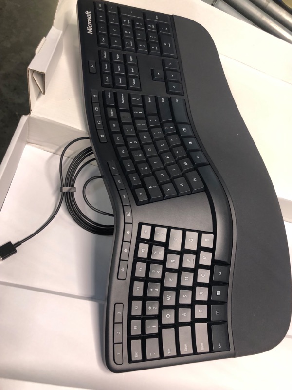 Photo 1 of Microsoft Ergonomic Keyboard - Black. Wired, Comfortable, Ergonomic Keyboard with Cushioned Wrist and Palm Support. Split Keyboard. Dedicated Office Key.