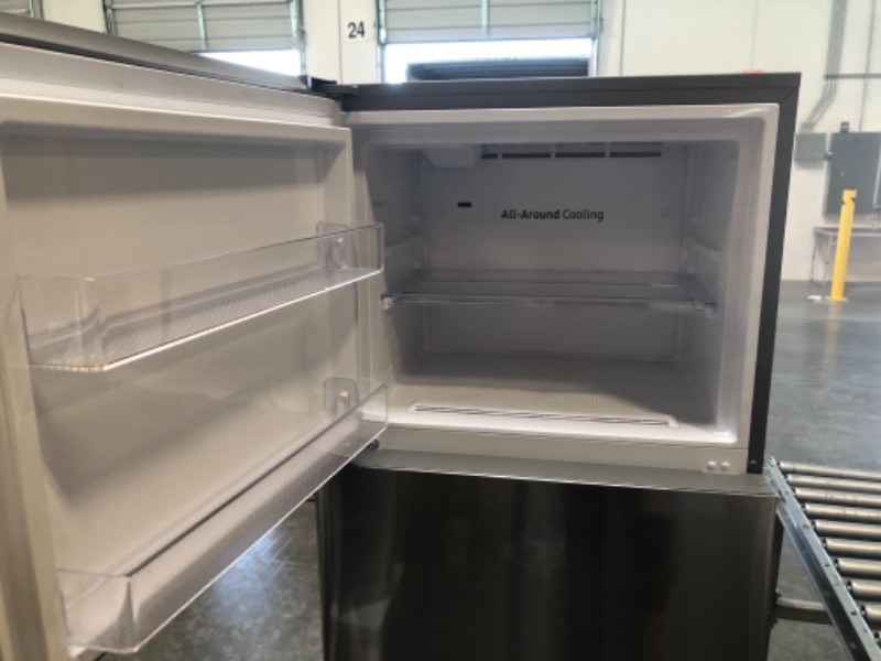 Photo 1 of Samsung 28 Inch Wide 15.6 Cu. Ft. Energy Star Certified Top Freezer Refrigerator with LED Lighting DENT ON FRONT OF DOOR 
