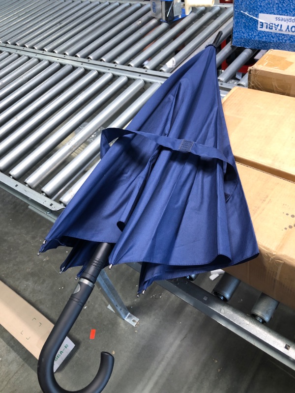 Photo 1 of Blue umbrella with curved handle