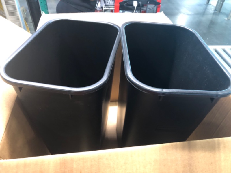 Photo 1 of 2 black rubbermaid trash cans 