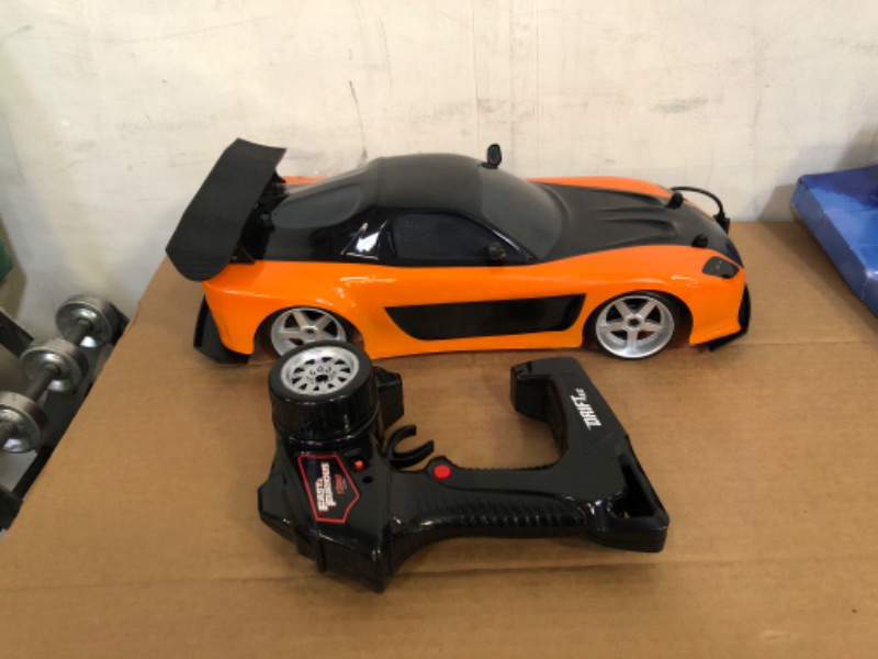 Photo 2 of Jada Toys Fast & Furious Han’s Mazda RX-7 Drift RC Car, 1: 10 Scale 2.4Ghz Remote Control Orange & Black, Ready to Run, USB Charging (Standard) (99700)