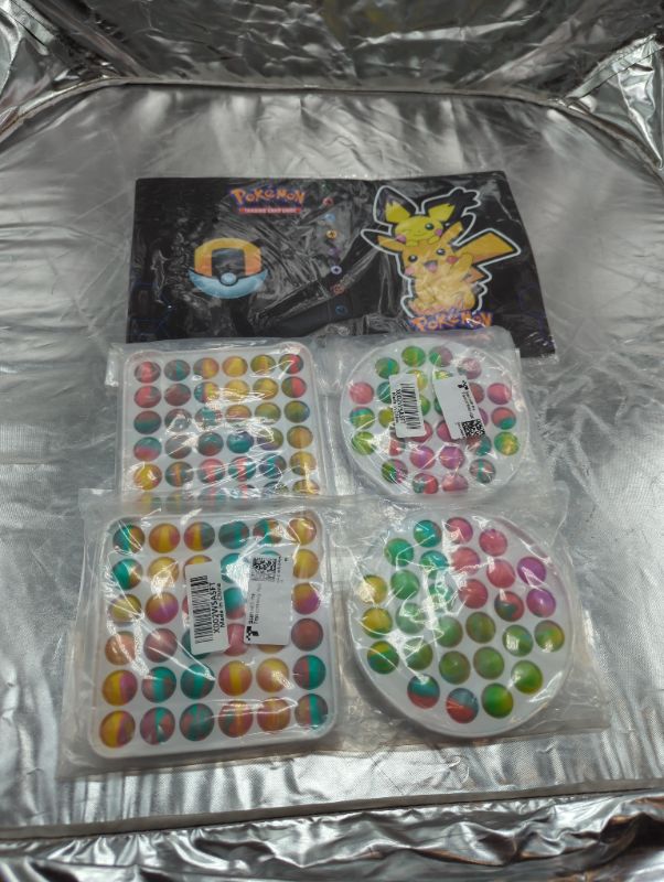 Photo 1 of Toy Bundle - Pop-It Sensory Toys, Pokemon Card Sleeves