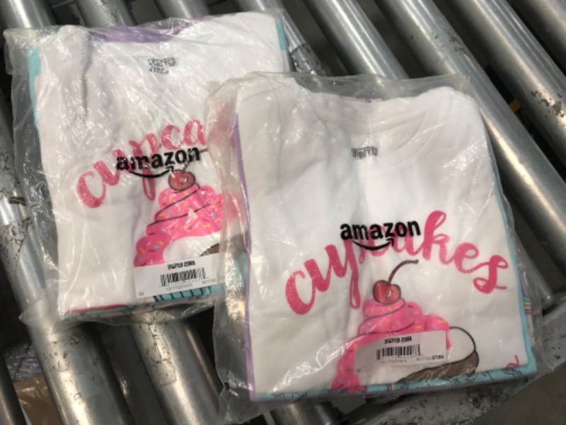 Photo 1 of BUNDLE OF 2, Amazon Essentials Girls and Toddlers' Short-Sleeve T-Shirt Tops (Previously Spotted Zebra), Multipacks 4 Purple/Blue/White, Cupcake/Unicorn Medium
