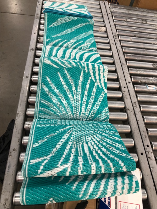 Photo 1 of 
Item is White/Teal Patio Rug for RV, with Four stakes and Carrying Bag 4-6" x 9'