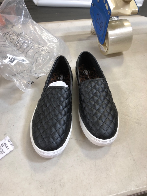 Photo 1 of BLACK AND WHITE SLIP ON SHOES ( SIZE: 4 ) 