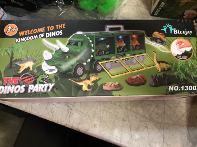 Photo 2 of BLUEJAY 21 Pack Dinosaur Toys for Kids 3-7, Dinosaur Truck with Oversized Dinosaur Map, Flashing Lights, Music and Roaring Sound, Kids Toys with 6 Pull Back Dinosaur Cars, 6 Dinosaur Toys (Green)