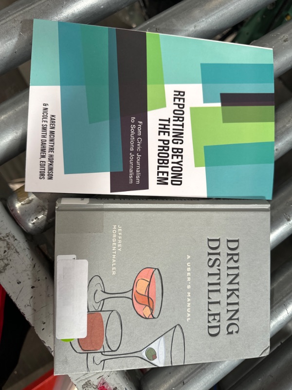 Photo 3 of "drinking distilled" and "reporting beyond the problem" books. 