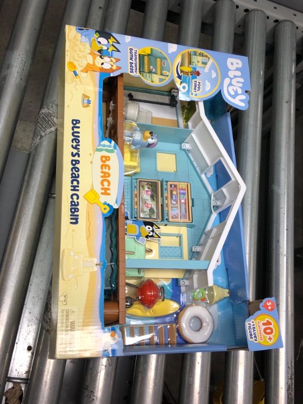 Photo 2 of Bluey Beach Cabin Playset, with Exclusive Figure with Goggles. Includes 10 Play Pieces and Sticker Sheet