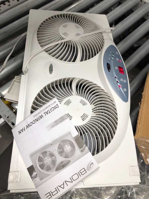 Photo 2 of *ONLY ONE SIDE WORKS* ** Bionaire Window Fan with Twin 8.5-Inch Reversible Airflow Blades and Remote Control, White White 2 Blades Electronic control with LCD screen Window Fan