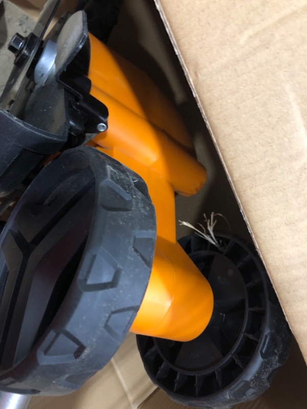 Photo 4 of ****USED *** ***OPEN BOX MAY BE MISSING HARDWARE*****

WORX WG896 12 Amp 7.5" Electric Lawn Edger & Trencher, 7.5in, Orange and Black & AmazonBasics 16/3 Vinyl Outdoor Extension Cord | Orange, 100-Foot