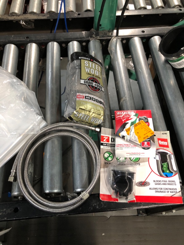 Photo 1 of (bundle) steel wool, drain seal, sponge and dishwasher hose.
