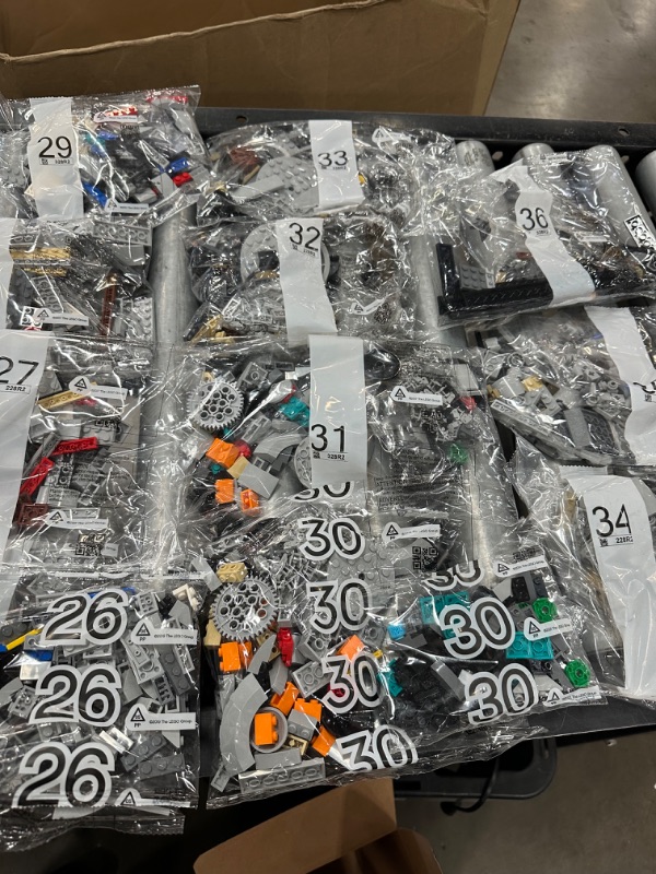 Photo 13 of LEGO Star Wars The Razor Crest 75331 Building Set for Adults (6,186 Pieces) all 48 bags of Legos, all 3 books and 1 platform piece. 