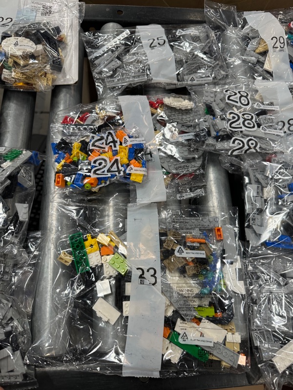 Photo 10 of LEGO Star Wars The Razor Crest 75331 Building Set for Adults (6,186 Pieces) all 48 bags of Legos, all 3 books and 1 platform piece. 