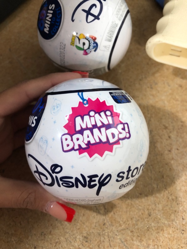 Photo 2 of (PACK OF 2) 5 Surprise Mini Brands Disney Store Series 1 Mystery Capsule Collectible