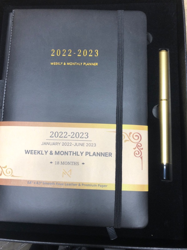 Photo 1 of Modern Mercantile Planner 2022-2023 - 5.8" x 8.3" Jan 2022 - June 2023 Monthly Planner with Weekly and Monthly Planning, Faux Leather Hard Cover, Gold Pen, Book Case, Bookmark and Elastic Band Black