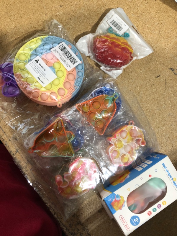 Photo 1 of 12 pack colorful Christmas pop-it toys with colorful Airpods Pro case 2 pack ball shape Pop-it and Lollipop Pop-it purse.