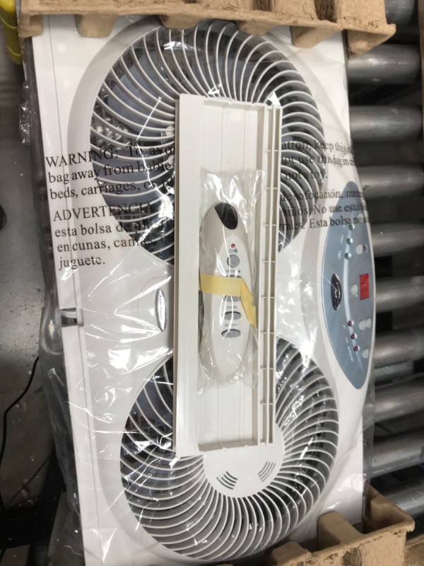 Photo 2 of *POWERS ON* Bionaire Window Fan with Twin 8.5-Inch Reversible Airflow Blades and Remote Control, White White 2 Blades Electronic control with LCD screen Window Fan