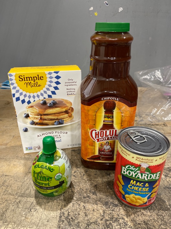 Photo 1 of MISCELLANEOUS FOOD BUNDLE - Cholula Sauce(expired 2/28/23), Chef Boyardee(expired 12/17/22) , Lime Juice, Pancake Mix