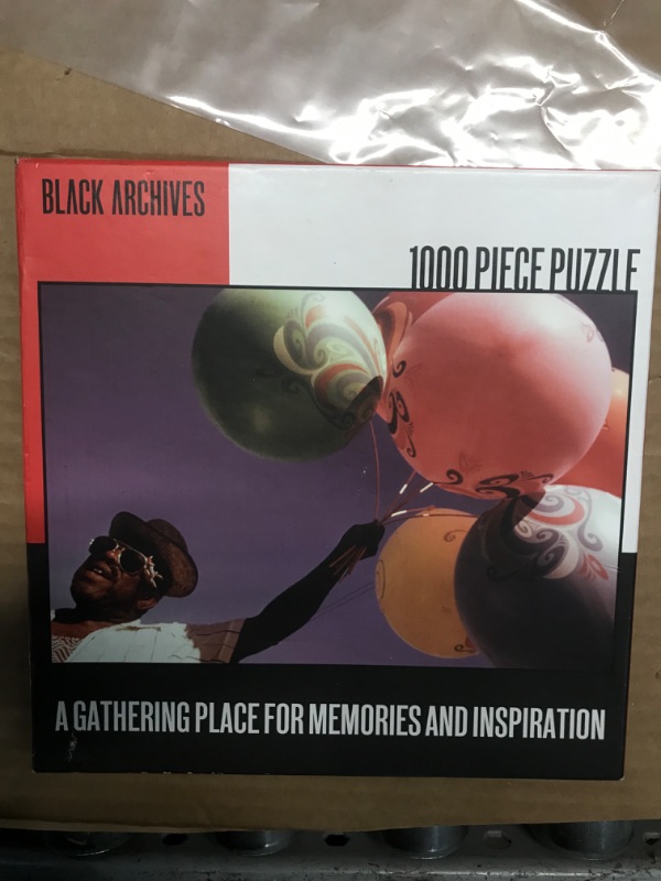 Photo 1 of Black Archives Puzzle: Man with Balloons 1000 Piece Puzzle
