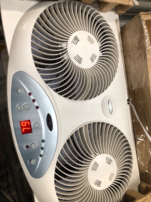 Photo 2 of **PARTS ONLY, BROKEN FAN BLADES** Bionaire Window Fan with Twin 8.5-Inch Reversible Airflow Blades and Remote Control, White 2 Blades Electronic control with LCD screen Window Fan