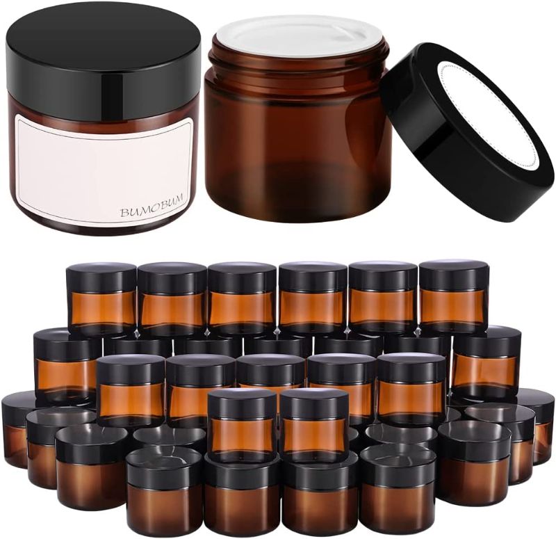 Photo 1 of 2 oz Round Amber Glass Jars, Bumobum 48 pack Cream Jars with Black Lids, White Labels & Inner Liners, Empty Cosmetic Containers for Cream, Lotion