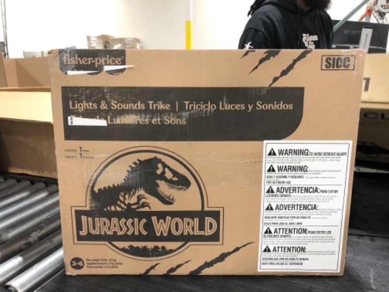 Photo 2 of Fisher-Price Jurassic World Velociraptor Dinosaur Tricycle, Toddler Toy Ride-On with Lights Sounds Walkie-Talkie and Storage Area