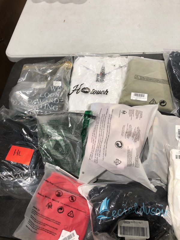 Photo 1 of Box lot of new and used clothing and shoes for men, women, and kids. Sold as is.