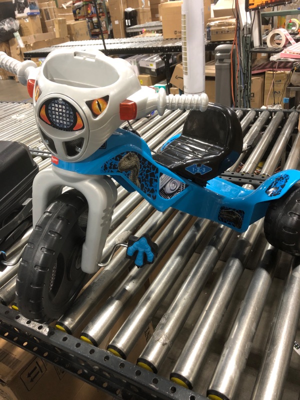 Photo 1 of Fisher-Price Jurassic World Velociraptor Dinosaur Tricycle, Toddler Toy Ride-On with Lights Sounds Walkie-Talkie and Storage Area