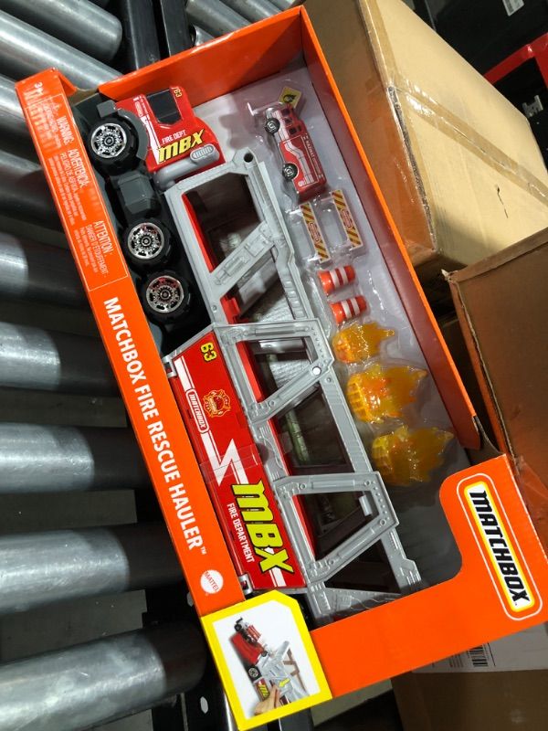 Photo 2 of ?Matchbox Fire Rescue Hauler Playset Themed Hauler with 1 Fire-Themed Vehicle, Holds 16 Cars, Easy-Release Ramp, 8 Accessories & Storage, for 3 & Up [Amazon Exclusive]