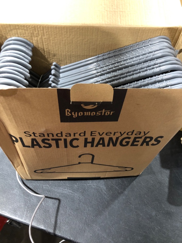 Photo 1 of 50 pack of gray hangers