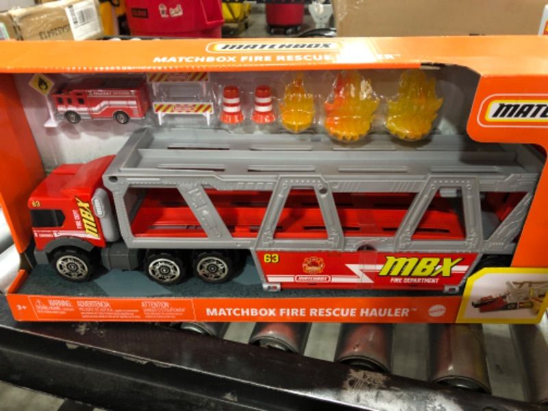 Photo 1 of ?Matchbox Fire Rescue Hauler Playset Themed Hauler with 1 Fire-Themed Vehicle, Holds 16 Cars, Easy-Release Ramp, 8 Accessories & Storage, for 3 & Up [Amazon Exclusive]
