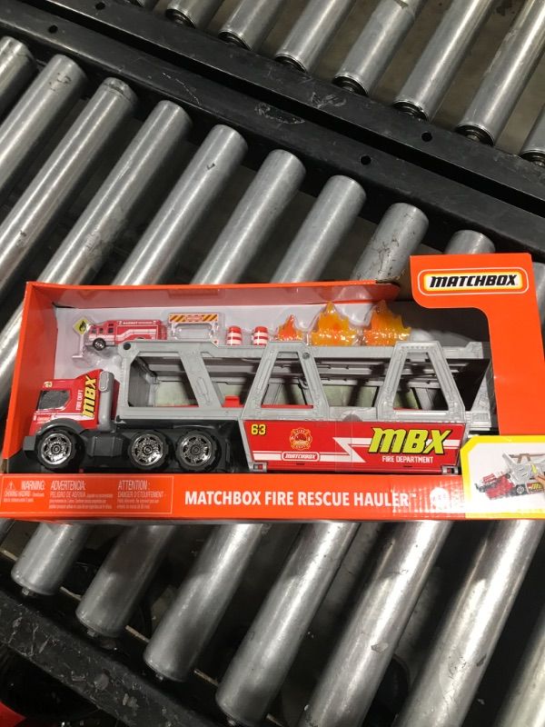 Photo 2 of ?Matchbox Fire Rescue Hauler Playset Themed Hauler with 1 Fire-Themed Vehicle, Holds 16 Cars, Easy-Release Ramp, 8 Accessories & Storage, for 3 & Up [Amazon Exclusive]