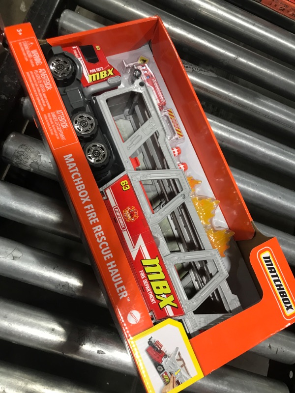 Photo 2 of ?Matchbox Fire Rescue Hauler Playset Themed Hauler with 1 Fire-Themed Vehicle, Holds 16 Cars, Easy-Release Ramp, 8 Accessories & Storage, for 3 & Up [Amazon Exclusive]