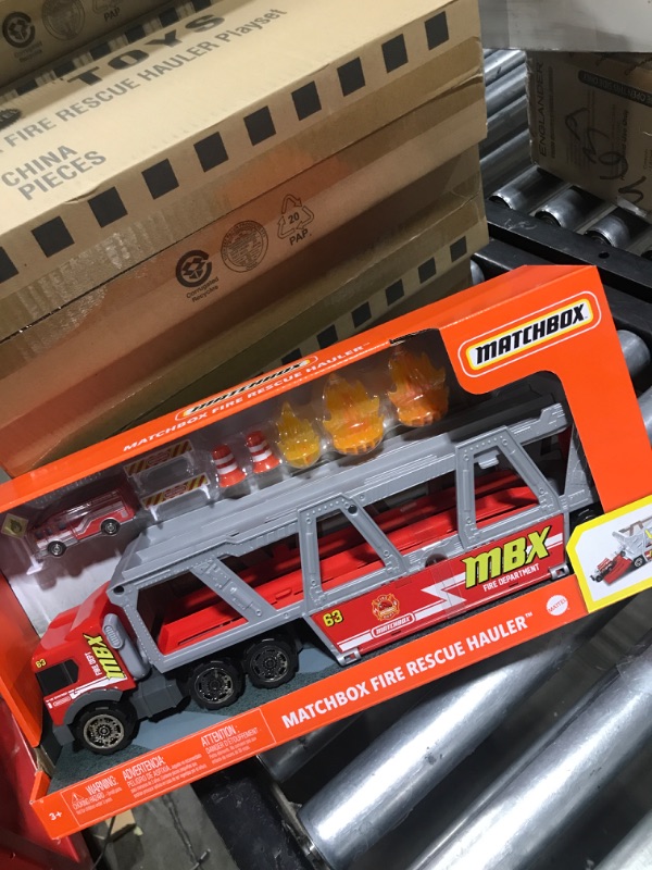 Photo 2 of ?Matchbox Fire Rescue Hauler Playset Themed Hauler with 1 Fire-Themed Vehicle, Holds 16 Cars, Easy-Release Ramp, 8 Accessories & Storage, for 3 & Up [Amazon Exclusive]