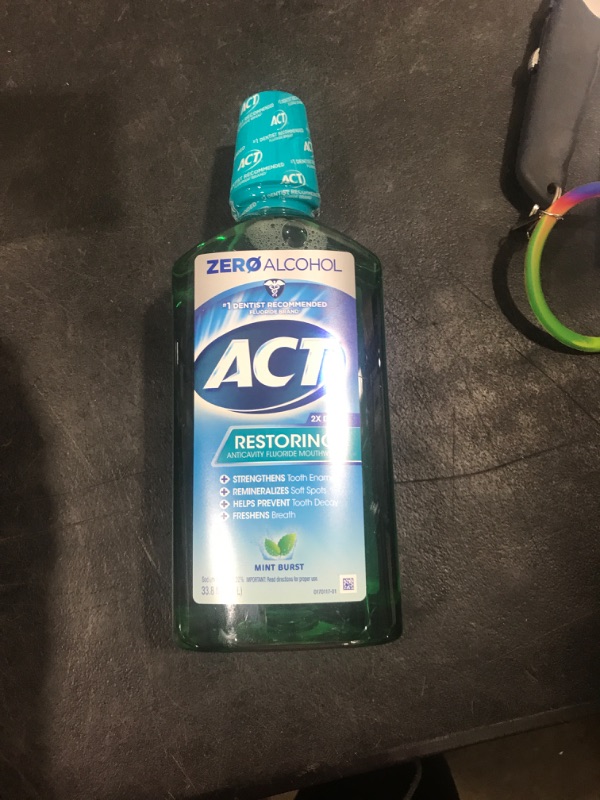 Photo 2 of ACT Restoring Zero Alcohol Fluoride Mouthwash 33.8 fl. oz. Strengthens Tooth Enamel, Mint Burst Green 33.8 Fl Oz (Pack of 1)