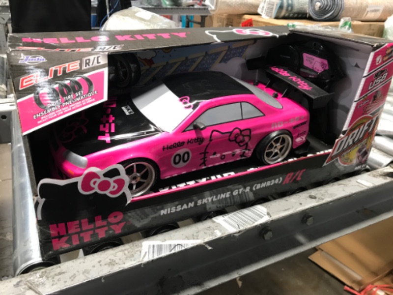 Photo 1 of **MINOR TEAR & WEAR**Jada Toys Hello Kitty Nissan Skyline GT-R (Bnr34) Drift Power Slide Elite R/C, USB Charging, with 4 Extra Tires, Pink