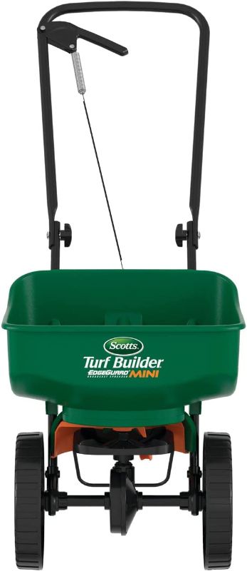 Photo 1 of **Needs cleaning** Scotts Turf Builder EdgeGuard Mini Broadcast Spreader - Holds Up to 5,000 sq. ft. of Lawn Product, Green
