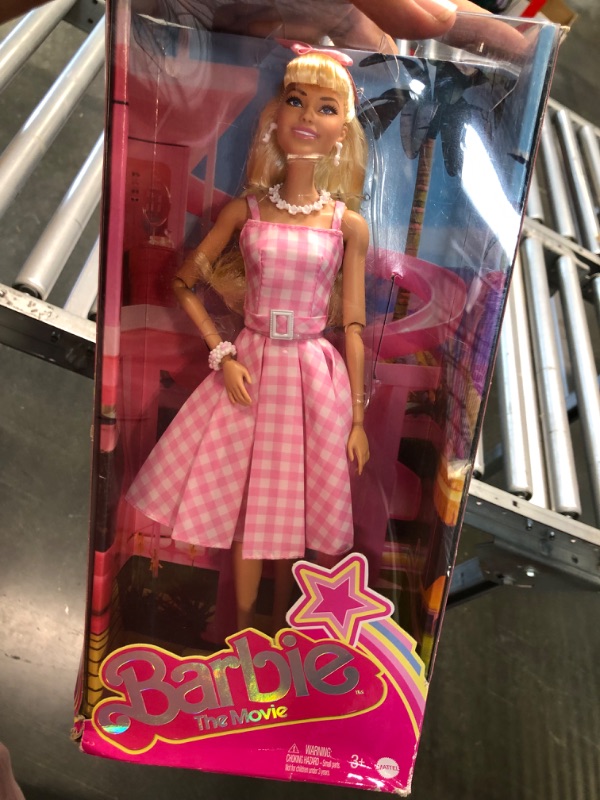 Photo 2 of Barbie The Movie Doll, Margot Robbie as Barbie, Collectible Doll Wearing Pink and White Gingham Dress with Daisy Chain Necklace