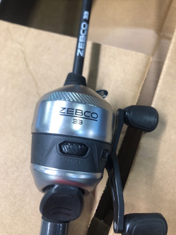 Photo 2 of Zebco 33 Spincast Reel and 2-Piece Fishing Rod Combo, Comfortable EVA Handle, Quickset Anti-Reverse Fishing Reel with Bite Alert 6 Foot - Spincast - Silver/Black