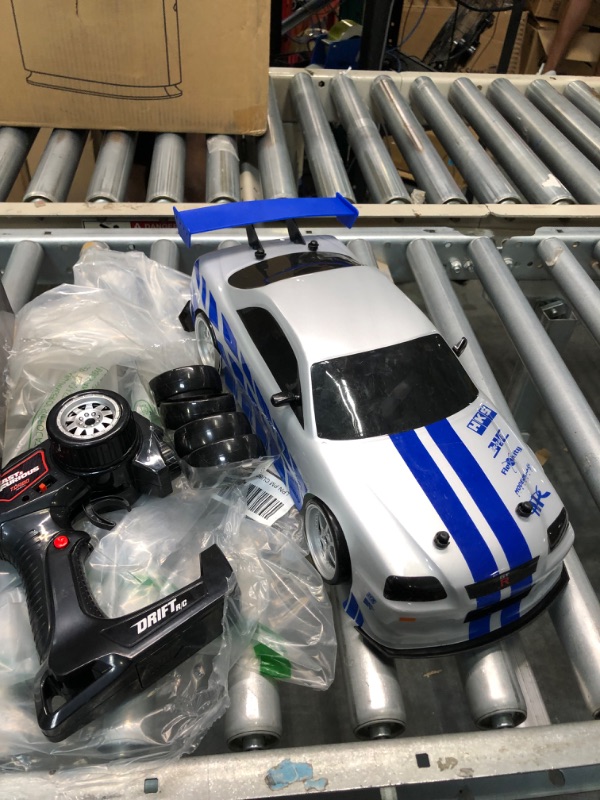 Photo 1 of Jada Toys Fast & Furious Brian's Nissan Skyline GT-R (BN34) Drift Power Slide RC Radio Remote Control Toy Race Car with Extra Tires, 1:10 Scale, Silver/Blue (99701)