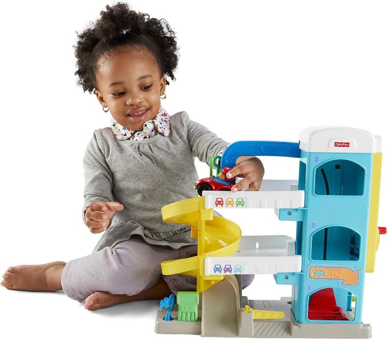 Photo 1 of Fisher-Price Little People Toddler Toy Helpful Neighbor's Garage Playset with Spiral Ramp and 2 Wheelies Cars for Ages 18+ Months