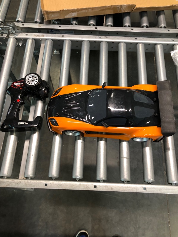 Photo 3 of Jada Toys Fast & Furious Han’s Mazda RX-7 Drift RC Car, 1: 10 Scale 2.4Ghz Remote Control Orange & Black, Ready to Run, USB Charging (Standard) (99700)