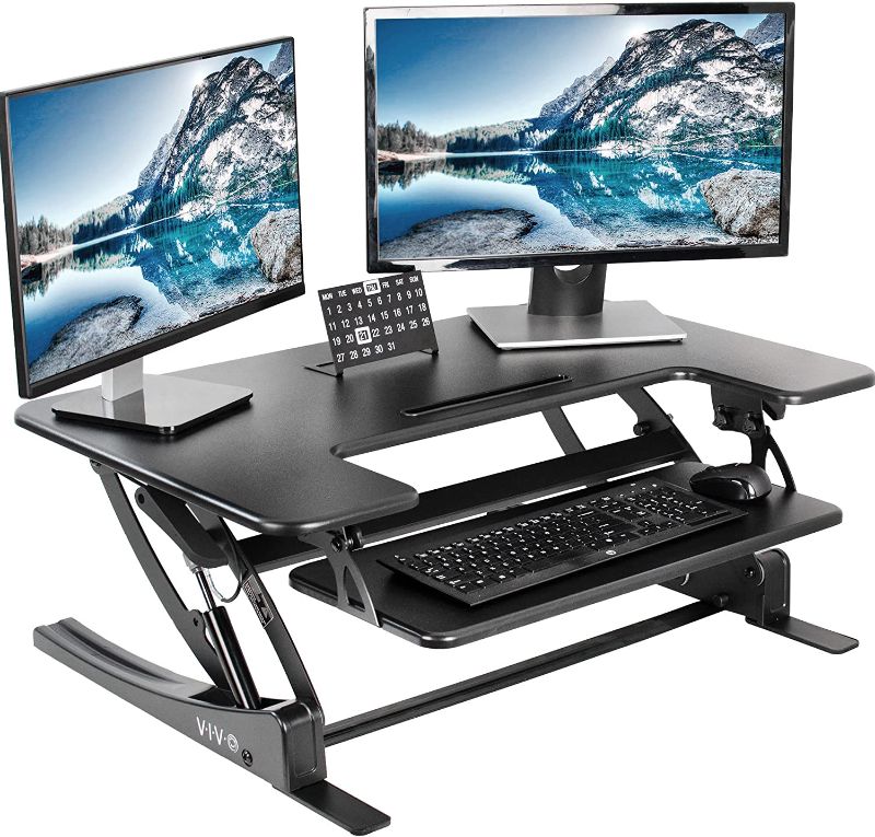 Photo 1 of FEZIBO 36” Height Adjustable Standing Desk Converter with USB Charging Port, Quick Sit to Stand Tabletop Dual Monitor, Stand Up Desk Riser for Home Office, Black 36 Inch Black